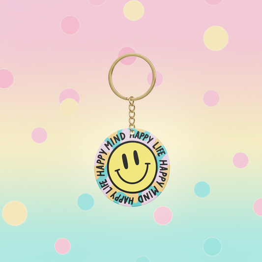 Keychain with smiley face design on a polka dot background